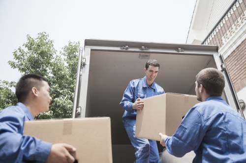 Van moving staff using safe lifting techniques