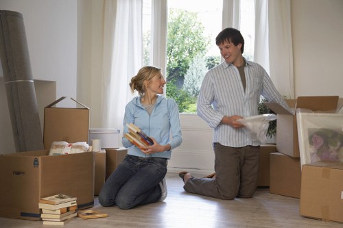 Professional movers carrying furniture through a narrow stairwell